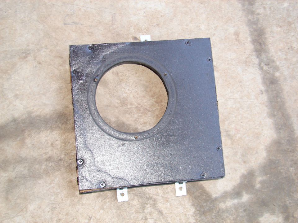 Wooden bracket with circular cutout, likely for a speaker, with metal mounting tabs
