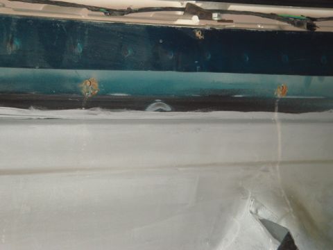 1996 Ford Bronco - This image shows a section of a vehicle's body with visible rust and wiring, not a complete vehicle.