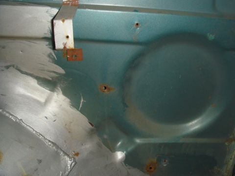 1996 Ford Bronco - Close-up view of a vehicle's inner fender, showing signs of rust and repair work done repairs.