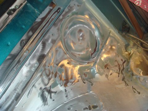 1996 Ford Bronco - Close-up view of a vehicle's inner fender, showing metal preparation for repair or painting.