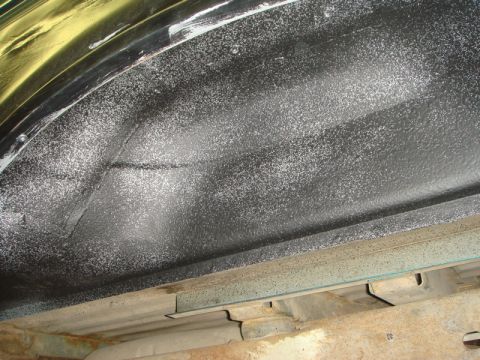 1996 Ford Bronco - Close-up of a vehicle's inner fender well, showing protective coating and structural elements.