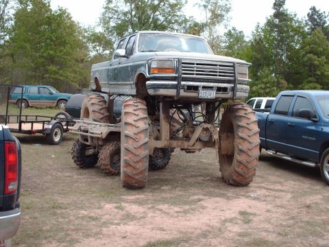 1990 Ford F-150 - This heavily modified truck features massive tires and a grille suggesting a 1992 model year, contradicting the registry's claim.