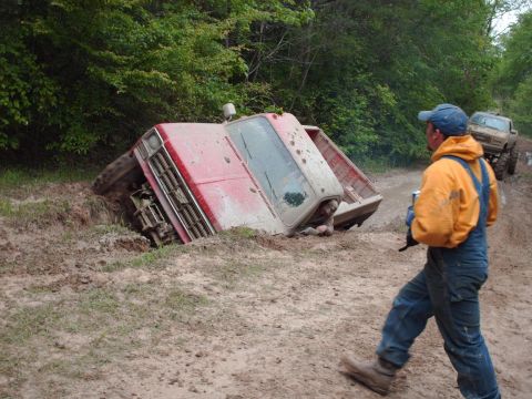 1990 Ford F-150 - Pickup truck stuck in mud after an off-road excursion. Another vehicle is visible in the background.