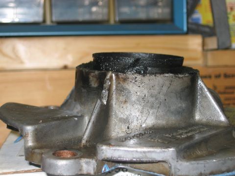 1992 Ford Bronco - Close-up of a transfer case part, likely from a Ford Bronco, showing wear and sealant.