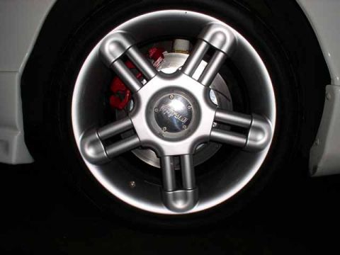 1996 Ford Probe - A custom wheel with a distinctive five-spoke design is shown, with a red brake caliper peeking through.