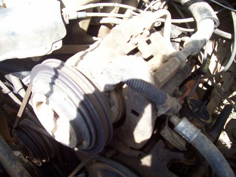 1989 Ford Bronco II - This image shows various engine components, including pulleys and hoses, within a vehicle's engine bay.