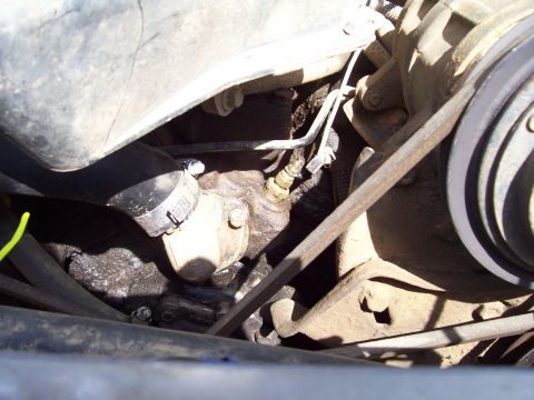1989 Ford Bronco II - Close-up view of engine parts, including a hose clamp and a sensor.