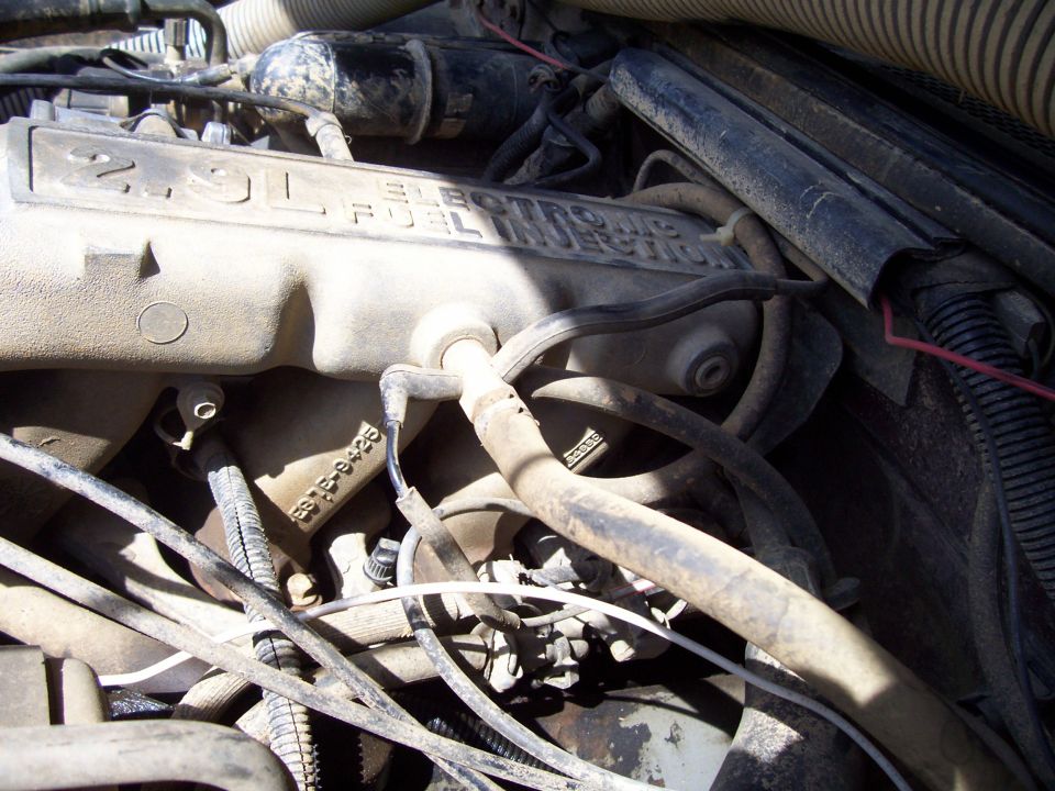 Dusty Ford 2.9L Electronic Fuel Injection intake manifold with vacuum hoses and wiring in engine bay