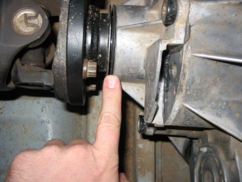 1995 Ford Bronco - Transfer case part shown with a finger indicating a seal area.