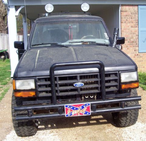 1989 Ford Bronco II - Front view of a black 1989 Ford Bronco II, equipped with a bull bar and auxiliary lights on the roof.