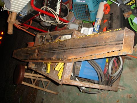 1989 Ford Bronco - A rusty metal structure with yellow safety markings and handwritten notes sits amidst various tools and equipment.
