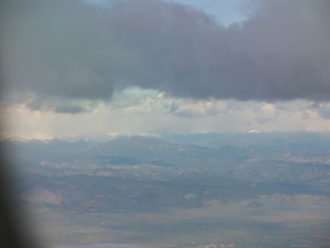 1995 Ford C-350 (Centurion Conversions) - A view from above shows clouds obscuring a vast mountain range and valley below.