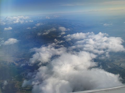 1995 Ford C-350 (Centurion Conversions) - Looking down from above the clouds at the landscape below.