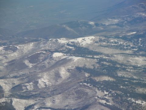 1995 Ford C-350 (Centurion Conversions) - A vast expanse of mountains shows patches of snow and scattered evergreen trees.
