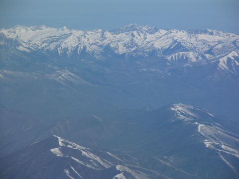 1995 Ford C-350 (Centurion Conversions) - An aerial view shows vast, snow-covered mountain peaks stretching across the horizon.