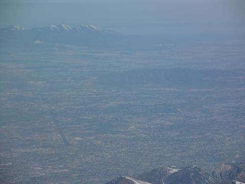 1995 Ford C-350 (Centurion Conversions) - An expansive view of a city between mountain ranges, seen from a high vantage point.