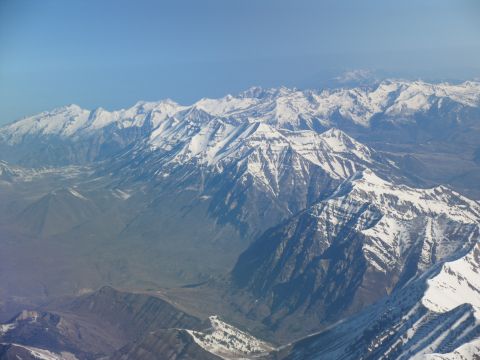 1995 Ford C-350 (Centurion Conversions) - Aerial view of snow-covered mountain ranges stretching across the horizon.