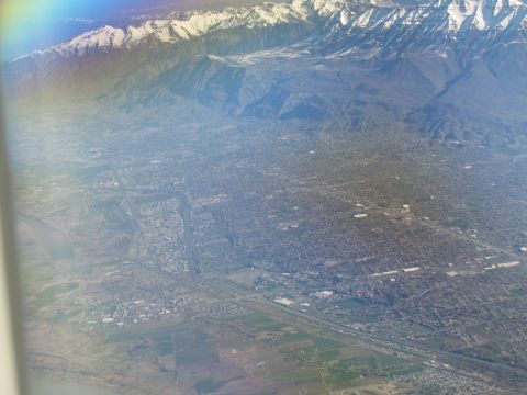 1995 Ford C-350 (Centurion Conversions) - An aerial perspective captures a city at the base of , snow-covered mountains.