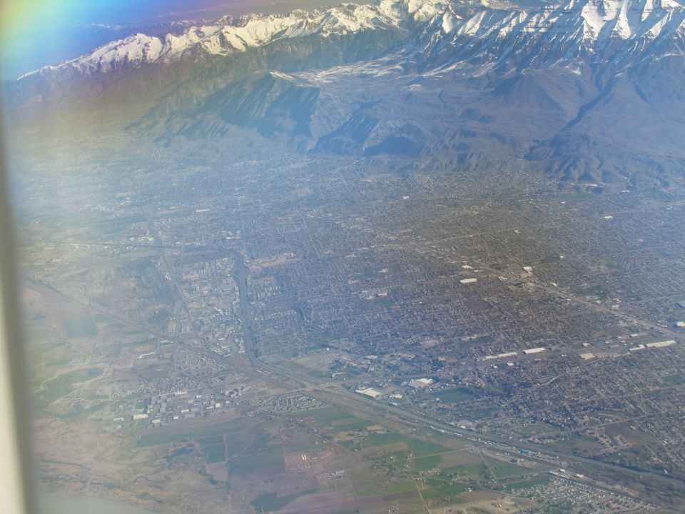 Aerial view of a city with snow-capped mountains