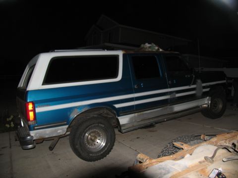 1995 Ford C-350 (Centurion Conversions) - Side view of a 1995 Ford C-350 (Centurion Conversions) pickup truck with a camper shell.