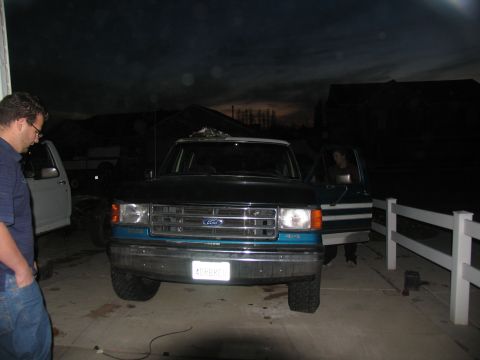 1995 Ford C-350 (Centurion Conversions) - A dark blue and teal Ford F-Series truck is parked in a driveway at dusk, with a person in the driver's seat.