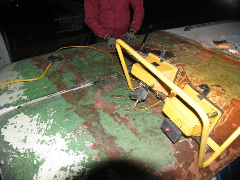 1995 Ford C-350 (Centurion Conversions) - Work lights are set up on the peeling hood of a vehicle.
