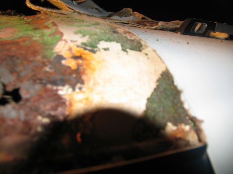 1995 Ford C-350 (Centurion Conversions) - Close-up of a heavily corroded metal surface, possibly from a vehicle's exterior.