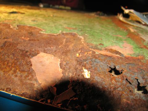 1995 Ford C-350 (Centurion Conversions) - This heavily rusted metal surface shows significant paint peeling, indicating severe corrosion.