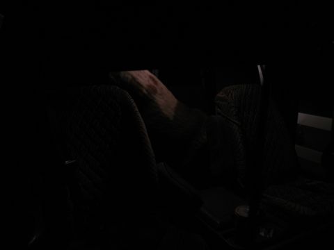1995 Ford C-350 (Centurion Conversions) - Interior view of dark patterned seats and dashboard, with a hand resting on the seat.
