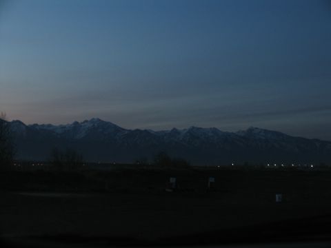 1995 Ford C-350 (Centurion Conversions) - Distant mountains loom under a fading sky as twilight settles over the landscape.