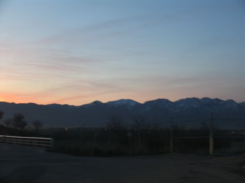 1995 Ford C-350 (Centurion Conversions) - A scenic view of mountains under a twilight sky, with a fence and road in the foreground.