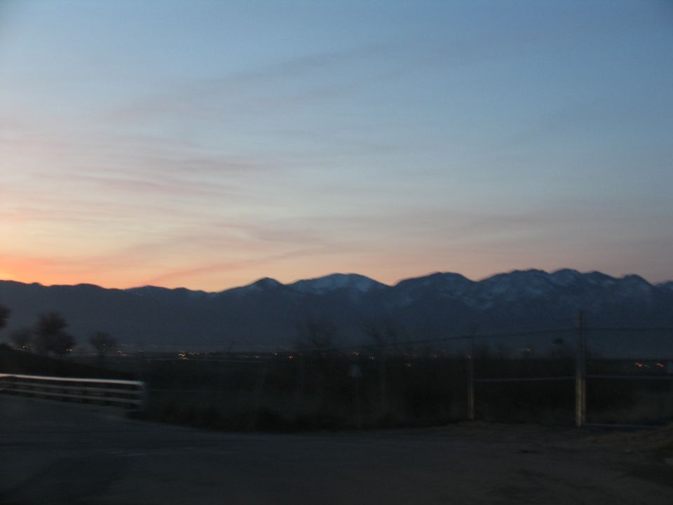 Mountain range at dusk with a fence in the foreground