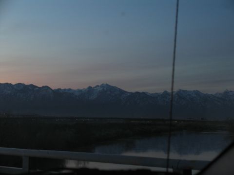 1995 Ford C-350 (Centurion Conversions) - Distant mountains are visible across a body of water at dusk.