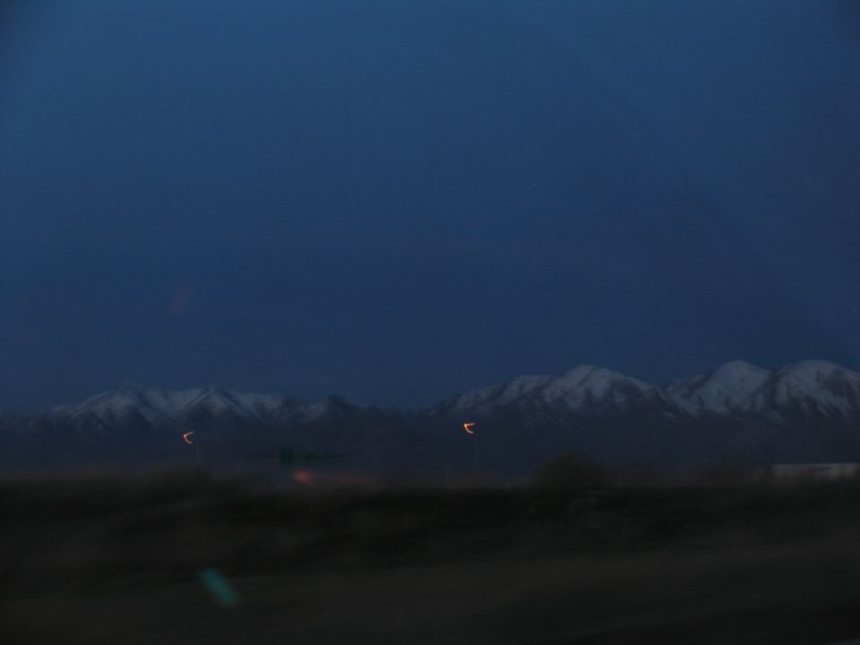 Snow-capped mountains at dusk with blurred foreground
