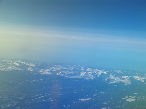 1995 Ford C-350 (Centurion Conversions) - Aerial view of a vast mountain range covered in snow under a clear blue sky.