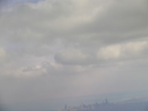 1995 Ford C-350 (Centurion Conversions) - A hazy view of a city skyline under a cloudy sky.