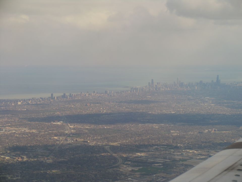 Aerial view of a city skyline with a body of water in the background