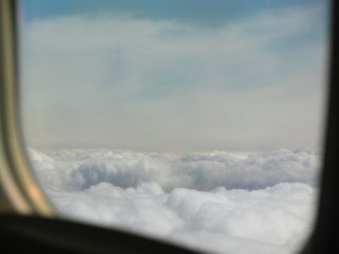1995 Ford C-350 (Centurion Conversions) - Looking out the window at clouds from an airplane.