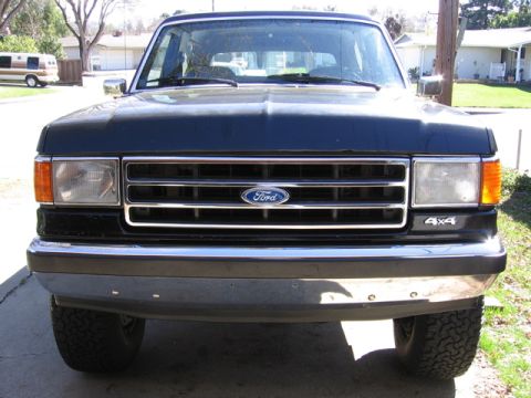 1989 Ford Bronco - Front view of a 1989 Ford Bronco, showing the grille and 4x4 badging.