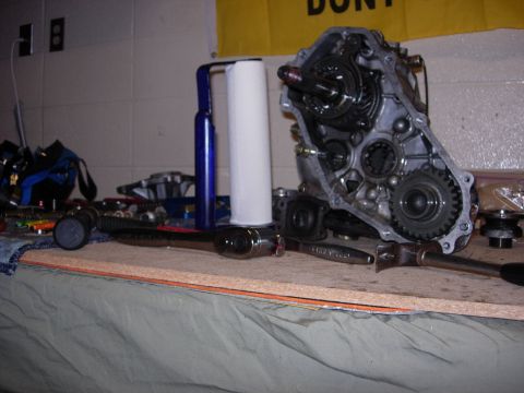 1985 Toyota Hilux - Tools and an open transmission housing are laid out on a workbench, suggesting a repair or assembly process.