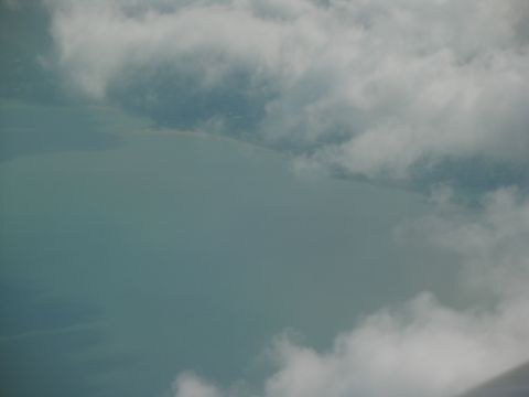 1995 Ford C-350 (Centurion Conversions) - View from above shows a vast expanse of water under a cloudy sky.