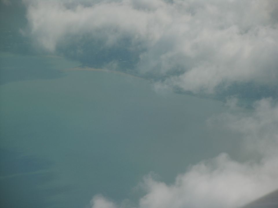 Aerial shot of a body of water partially obscured by clouds