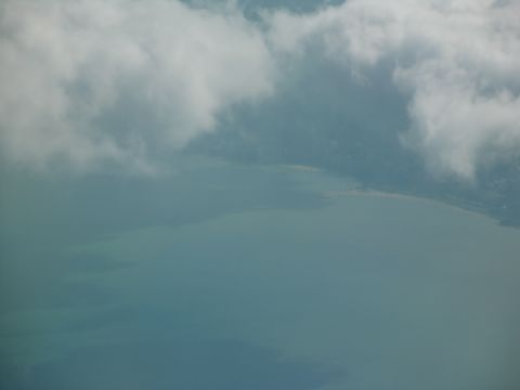 1995 Ford C-350 (Centurion Conversions) - Clouds obscure the view of the water and coastline from this aerial perspective.