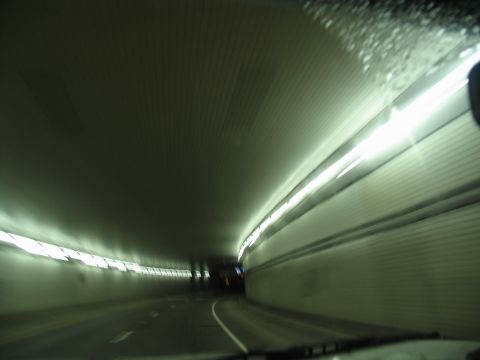 1995 Ford C-350 (Centurion Conversions) - Driving through a tunnel with lights lining the walls and ceiling.