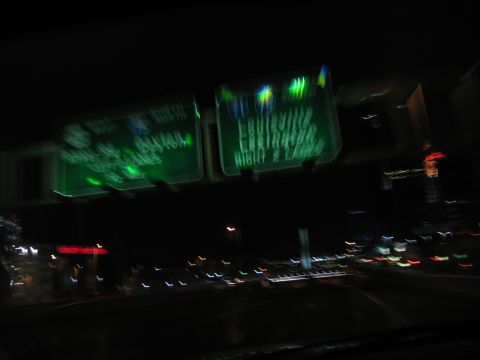 1995 Ford C-350 (Centurion Conversions) - Nighttime view of highway signs indicating directions to Louisville and Lexington.