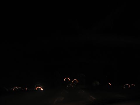1995 Ford C-350 (Centurion Conversions) - Blurry orange lights streak across a dark scene, suggesting motion at night.