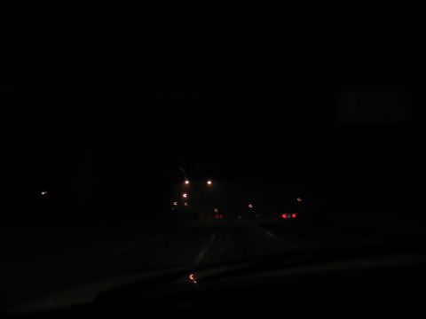 1995 Ford C-350 (Centurion Conversions) - View from inside a vehicle driving on a dark road at night with distant lights visible.