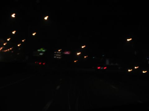 1995 Ford C-350 (Centurion Conversions) - Driving at night on a highway with blurred lights from streetlamps and other vehicles.