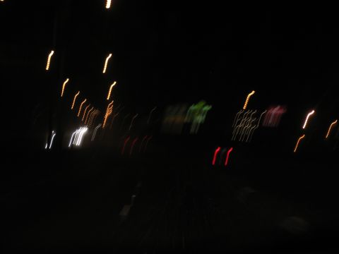 1995 Ford C-350 (Centurion Conversions) - Motion blur captures streaks of light from passing vehicles on a dark road.