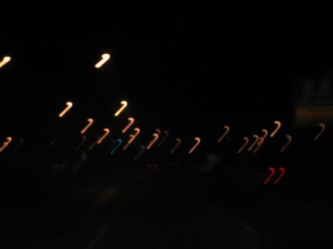 1995 Ford C-350 (Centurion Conversions) - Abstract streaks of light create a dynamic, blurry scene against a dark background.